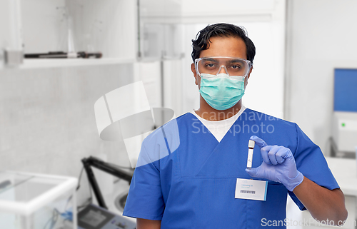 Image of indian male doctor in mask with blood in test tube