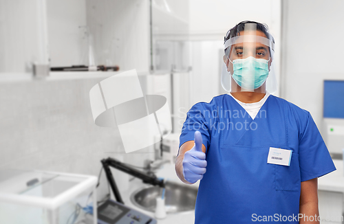 Image of doctor in mask and face shield showing thumbs up