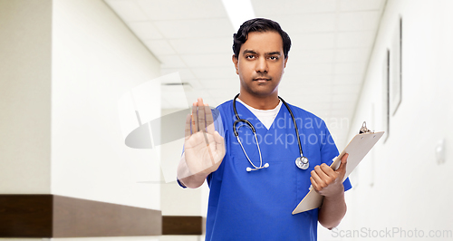 Image of indian doctor or male nurse showing stop gesture