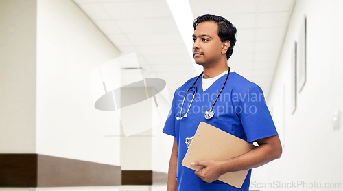 Image of indian male doctor with clipboard and stethoscope