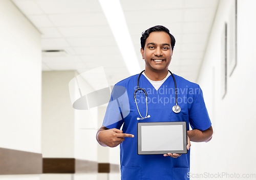 Image of happy doctor or male nurse showing tablet computer