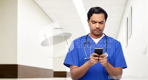 Image of indian doctor or male nurse using smartphone