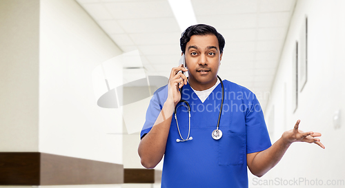 Image of indian doctor or male nurse calling on smartphone