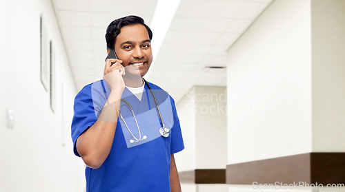 Image of indian doctor or male nurse calling on smartphone