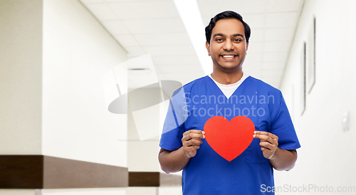 Image of indian male doctor with red heart on clipboard