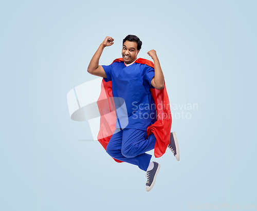 Image of doctor or male nurse in superhero cape jumping