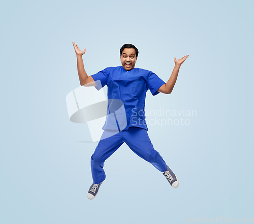 Image of doctor or male nurse with stethoscope jumping