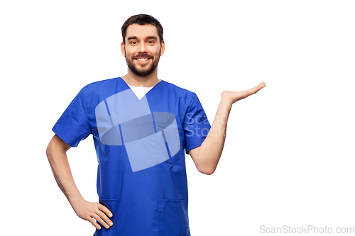 Image of smiling male doctor holding something on hand