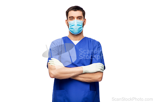 Image of male doctor in blue uniform, mask and gloves