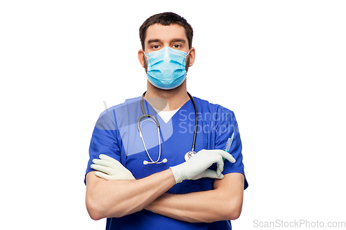 Image of male doctor in mask and gloves with syringe