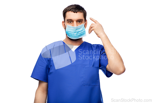 Image of male doctor in blue uniform in mask