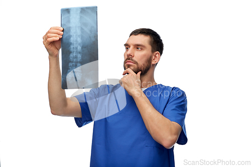 Image of doctor or male nurse looking at x-ray scan