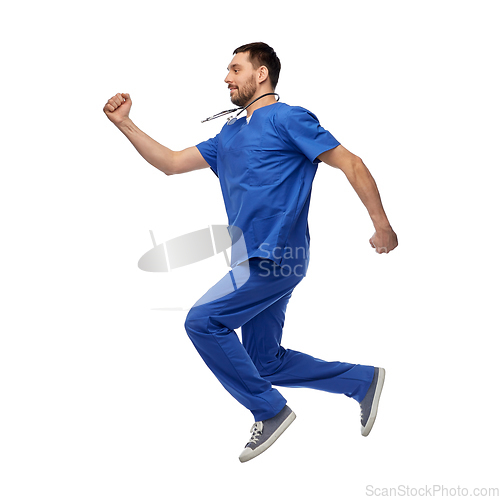 Image of happy smiling doctor or male nurse jumping in air