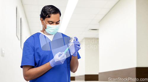 Image of indian doctor in mask with syringe and medicine