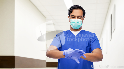 Image of indian male doctor in uniform, mask and gloves