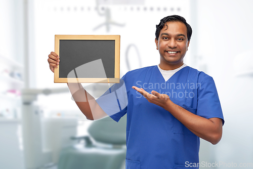 Image of indian male doctor or dentist with chalkboard