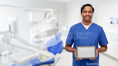 Image of doctor or male dentist showing tablet computer