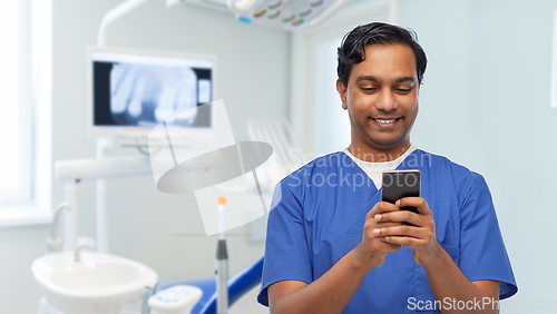 Image of smiling doctor or male nurse using smartphone