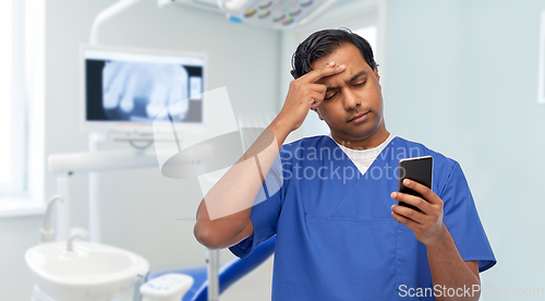 Image of indian doctor or male nurse using smartphone