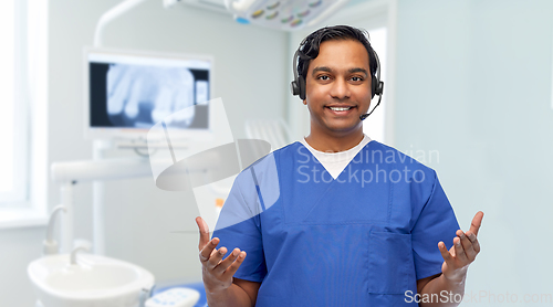 Image of smiling indian doctor or male nurse with headset