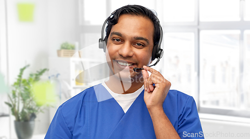 Image of smiling indian doctor or male nurse with headset