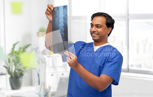 Image of happy indian doctor or male nurse with x-ray