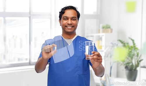 Image of indian doctor with medicine and glass of water