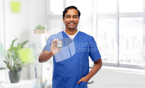Image of indian doctor or male nurse holding medicine