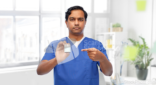 Image of indian doctor or male nurse holding medicine