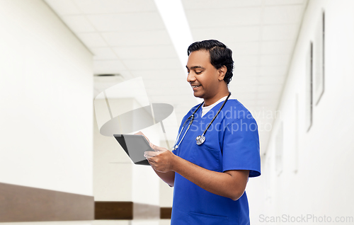 Image of indian doctor or male nurse using tablet computer