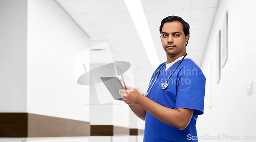 Image of indian doctor or male nurse using tablet computer