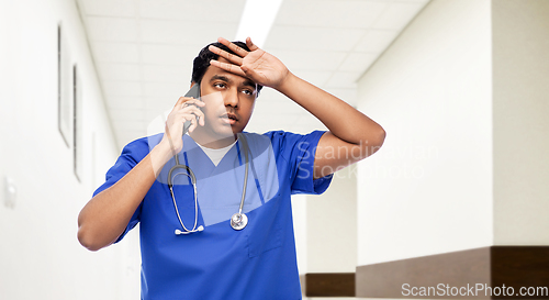 Image of indian doctor or male nurse calling on smartphone