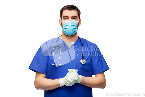 Image of male doctor in blue uniform, mask and gloves