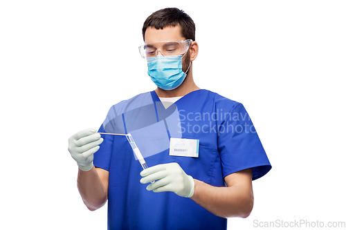 Image of male doctor in mask with cotton swab and test tube