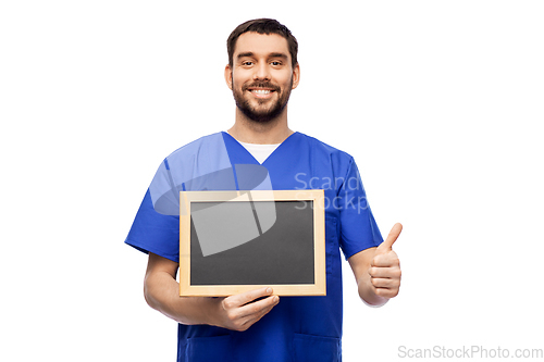Image of happy smiling male doctor or nurse with chalkboard