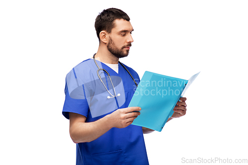 Image of male doctor reading medical report in folder