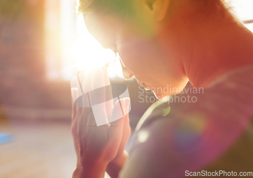 Image of close up of woman meditating at yoga studio