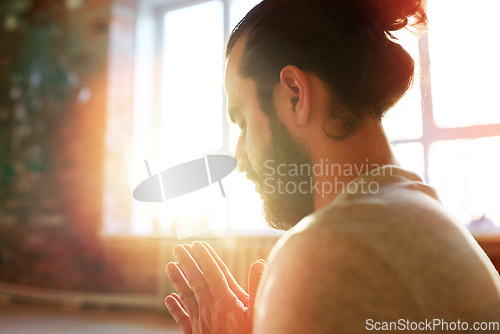 Image of close up of man meditating at yoga studio