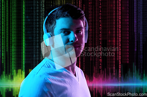 Image of man in headphones over neon lights and binary code