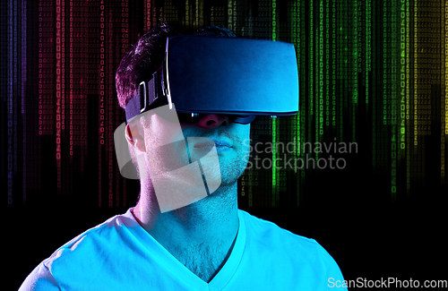 Image of man in vr glasses in neon lights over binary code