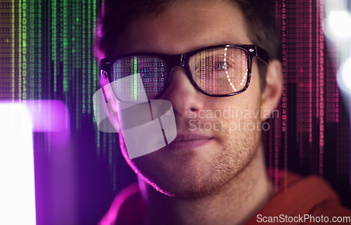 Image of man in glasses over neon lights and binary code