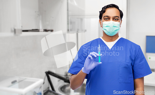 Image of indian male doctor in mask with vaccine in syringe