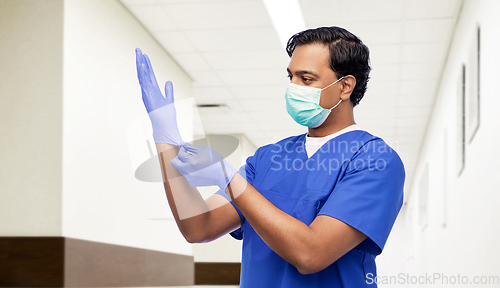 Image of indian male doctor in uniform, mask and gloves