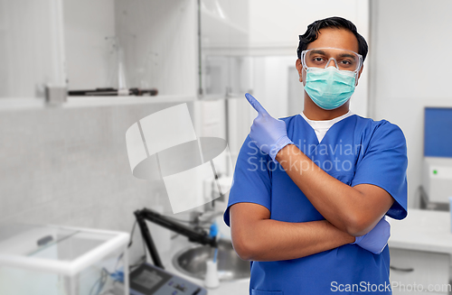 Image of indian male doctor in mask showing something