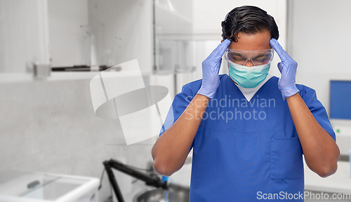 Image of stressed doctor or male nurse having headache