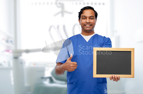 Image of indian male doctor or dentist with chalkboard