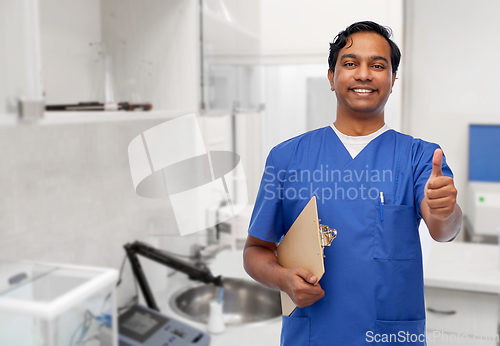 Image of smiling doctor or male nurse showing thumbs up