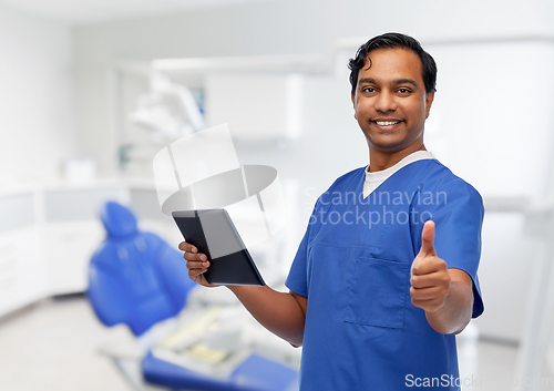 Image of male doctor with tablet pc showing thumbs up