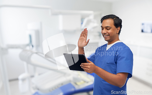 Image of doctor or male dentist has video call on tablet pc