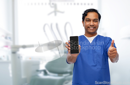 Image of doctor or dentist with phone showing thumbs up